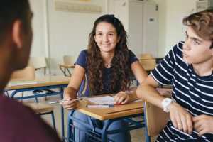 A diverse group of students engaged in a discussion, representing questions to ask schools for troubled teens.