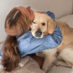 The Ballad of the Adopted Child 7 A teenage girl joyfully playing with her pet dog at home, highlighting the bond of emotional support animals for teens.