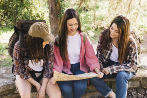 A group of teens enjoying a campfire at night, highlighting the importance of a post camp pest check for teens.