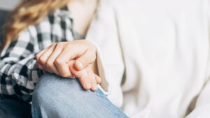 Two hands reaching out for help, symbolizing support in substance abuse recovery programs.