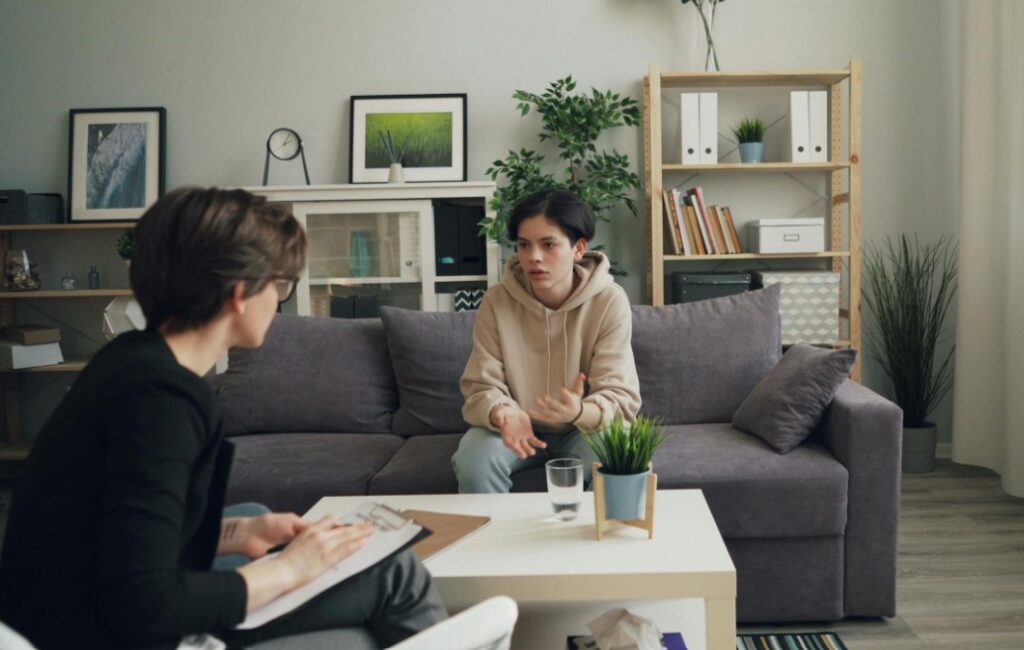 A serene mediation session with a family counselor and teens, emphasizing family mediation for teen therapeutic care.