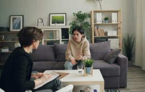 A serene mediation session with a family counselor and teens, emphasizing family mediation for teen therapeutic care.