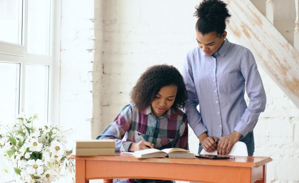 How Parents Can Help Teens Turn Phlebotomy Practice Test Results Into a Smarter Study Plan 1 Mother helping her teenage daughter with homework at a desk