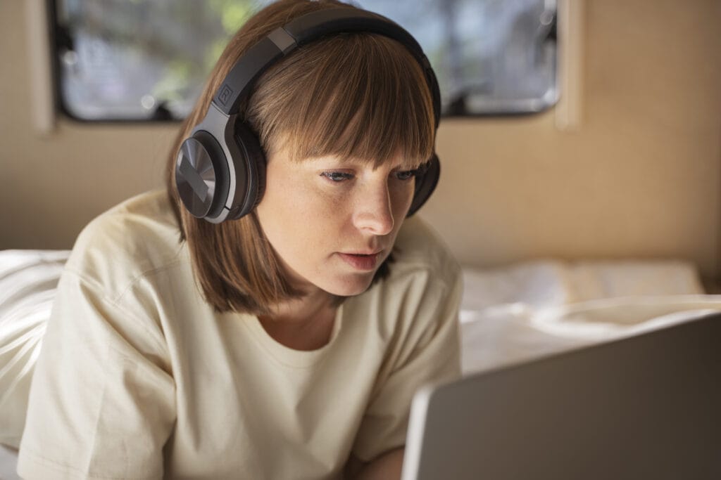 When AI Becomes Your Teen’s Best Friend: What Parents Need to Notice 1 Teenager wearing headphones while studying on a laptop