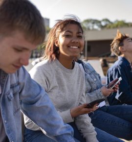 A diverse group of teens engaging in a friendly outdoor activity, showcasing ways to help ADHD teens build friendships.