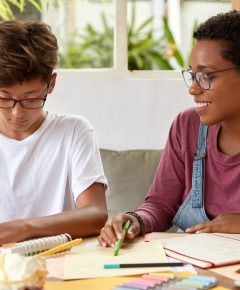 A tutor and a teen student working together on math problems, illustrating how to help teens overcome math struggles.