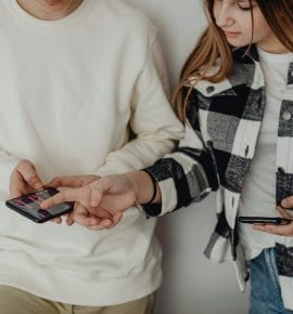 social media addiction attorney - A teenager lying on a bed, staring at a phone, highlighting issues related to social media