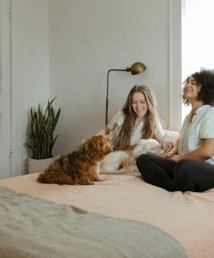 A teenager cuddles with a dog, showcasing the bond that illustrates how family pets support teenage mental health.