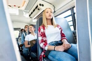 group of teen scholars riding school bus together